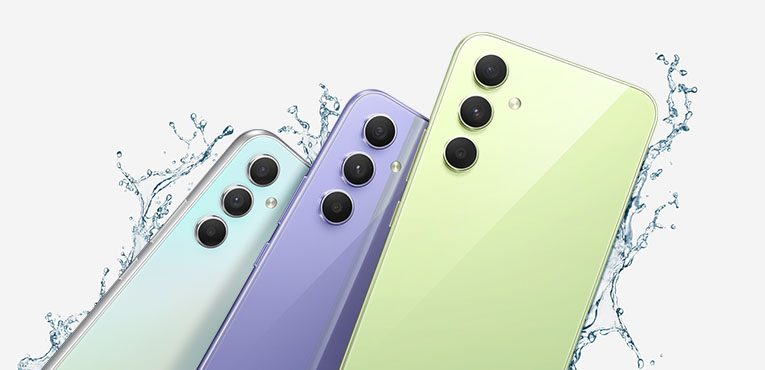 Um combo com o Galaxy A54 5Gs e o Galaxy A34 5Gs mostra as metades superiores de suas partes traseiras, uma em Violeta Absurdo, outra em Absurdo Verde-Lima e a outra em Prata. Gotas de água aparecem sendo espirradas ao redor dos dispositivos.