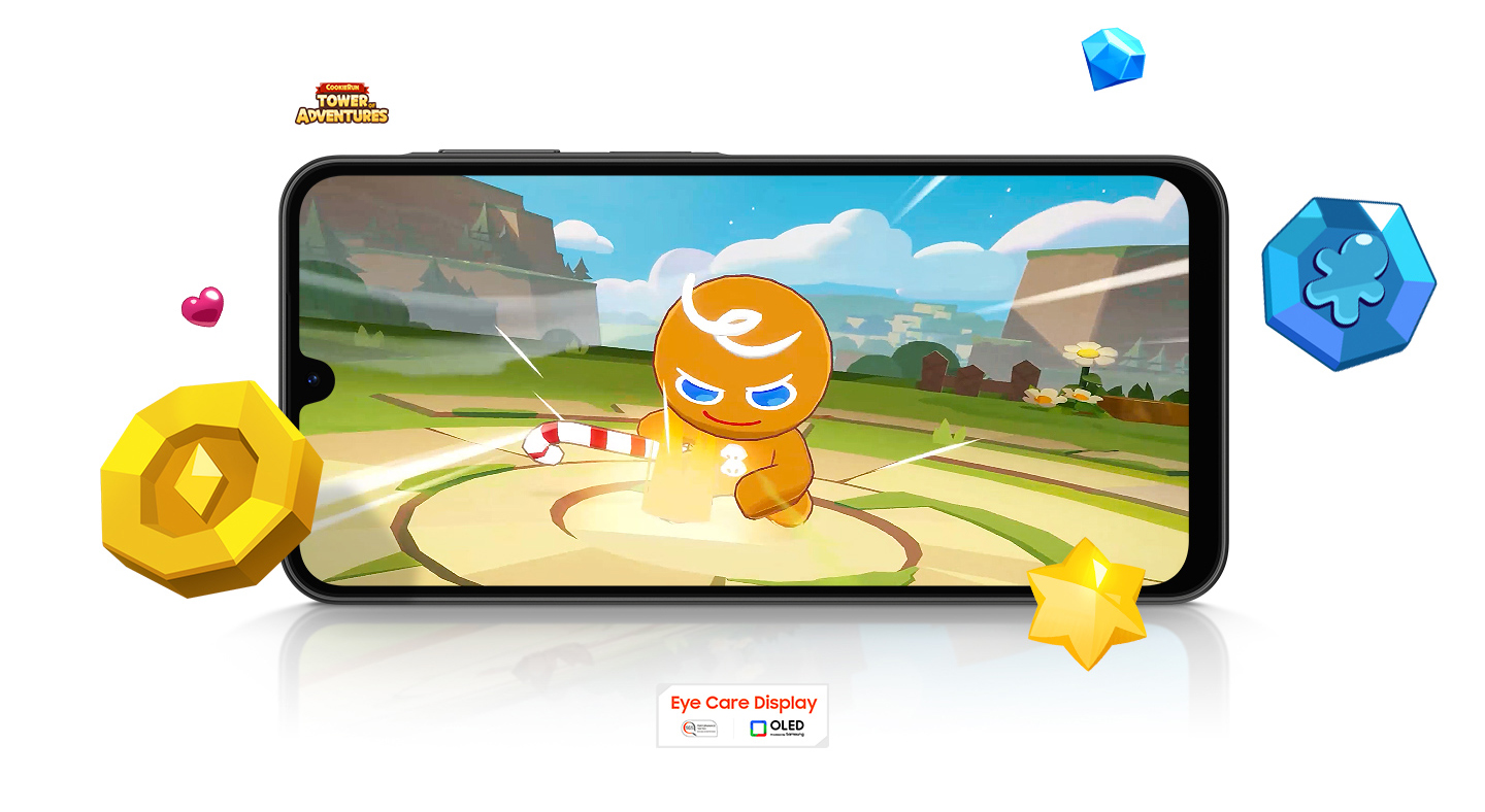 Vemos um Galaxy A26 5G rodando o jogo Cookie Run no modo paisagem. Itens do jogo estão espalhados ao redor da tela. Próximos ao dispositivo estão os logotipos de COOKIE RUN TOWER OF ADVENTURES, Eye Care Display e OLED Technology.